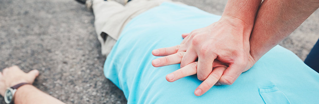 A person has collapsed. A bystander performs CPR.