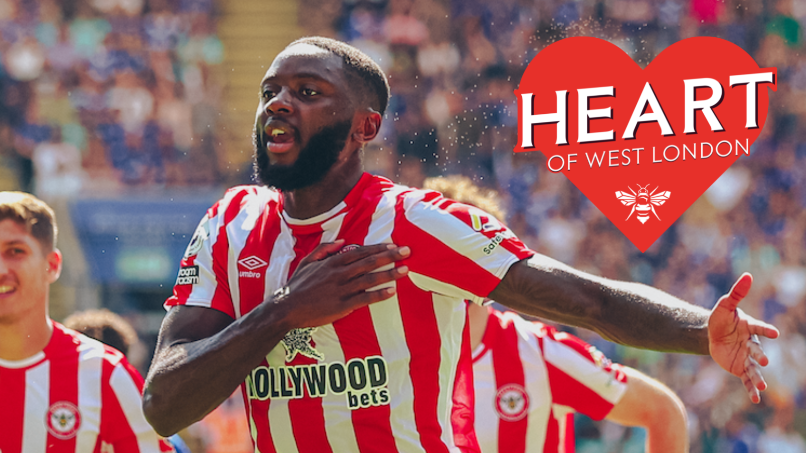 Brentford player holding his heart in a red & white striped shirt with the Heart of West London logo on the top right