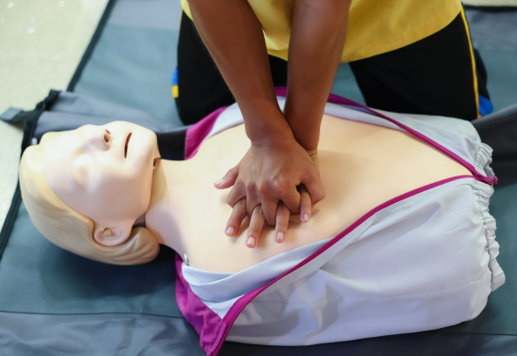 Person practicing CPR on mannequin