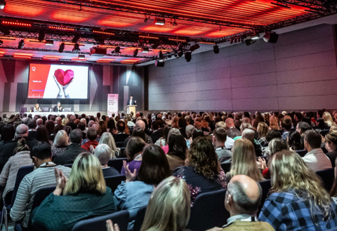 Group of people seated in large conference hall