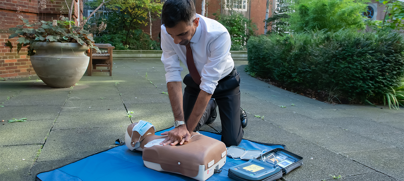 Dr Habib Naqvi practices chest compressions on a manikin