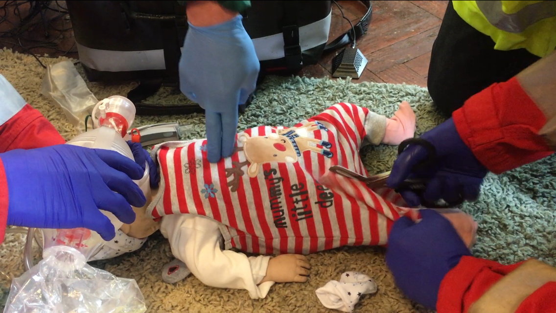 Baby Manikin being given CPR