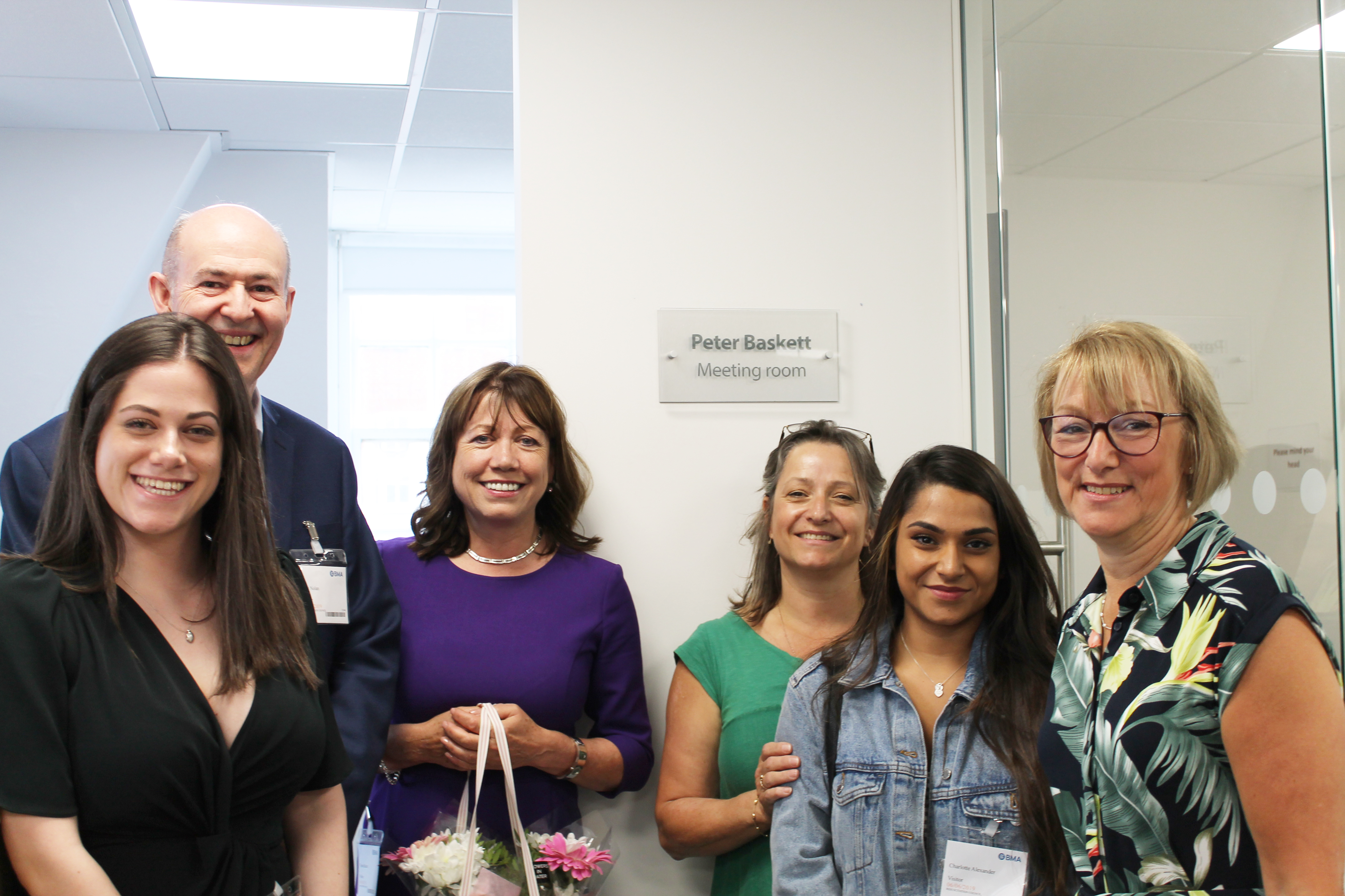 The family of Peter Baskett stand outside the room dedicated to his memory alongside members of Resuscitation Council UK