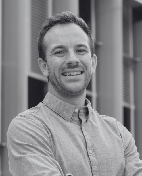 black and white headshot of Adam Boulton