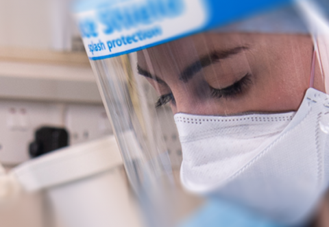 Close up image of a young woman wearing Level 3 PPE in a healthcare setting