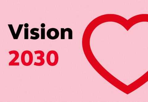 A large graphic of a heart, with text that says 'Vision 2030'