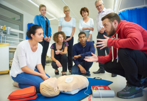 Group of people having defibrillation training 