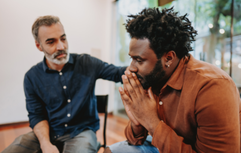 Man providing support for another man