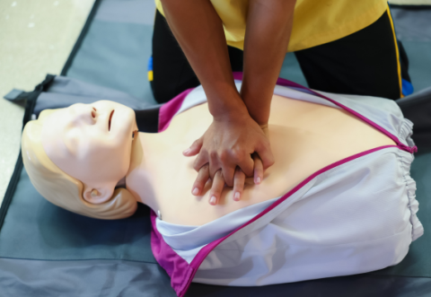 Person practicing CPR on mannequin