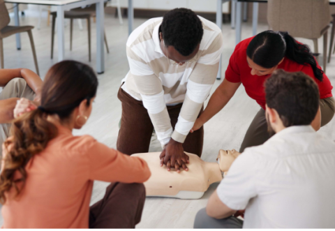 Group of people learning how to do CPR