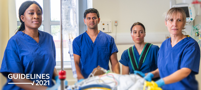 A group of healthcare professionals transport a patient in a hospital