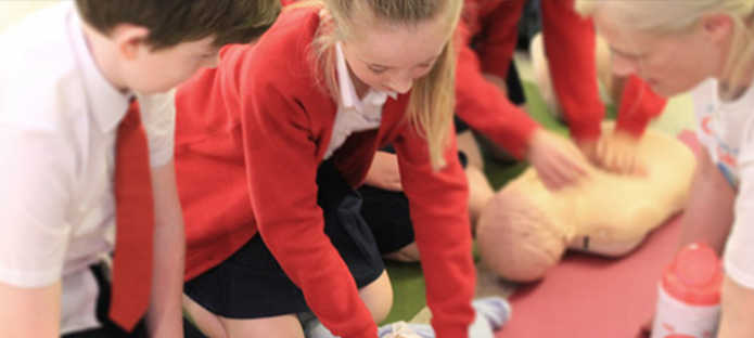 School children learning CPR 