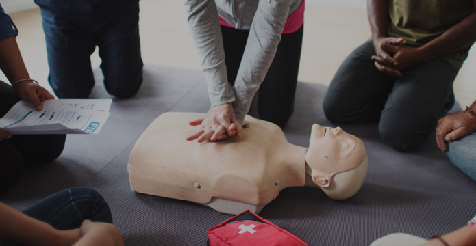 Hands on chest of manikin performing CPR demonstration