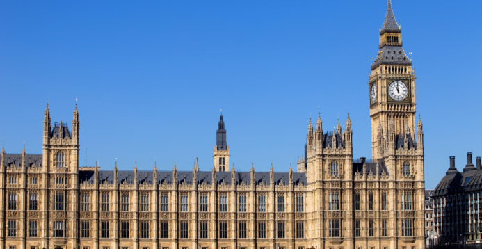 An image of Westminster Palace with a bright blue sky above