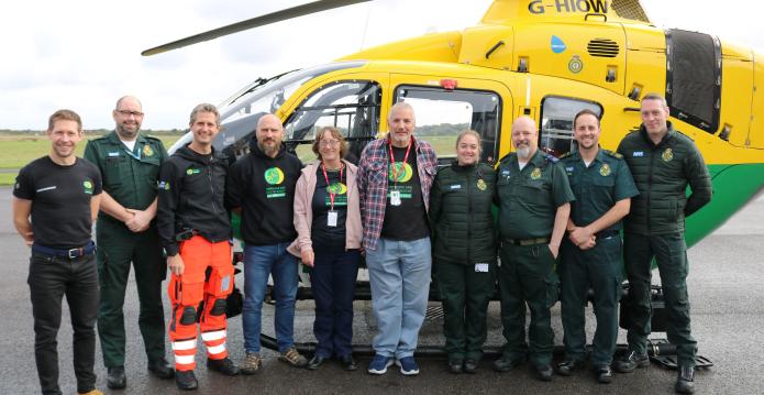 Nina and her husband, Jon, pictured with the ambulance and air ambulance crews who treated her.