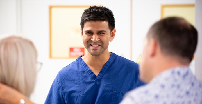 healthcare professional talking to cardiac arrest survivor about discharge resource