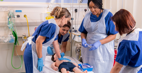 group of clinicians attending to an in-hospital paediatric resuscitation